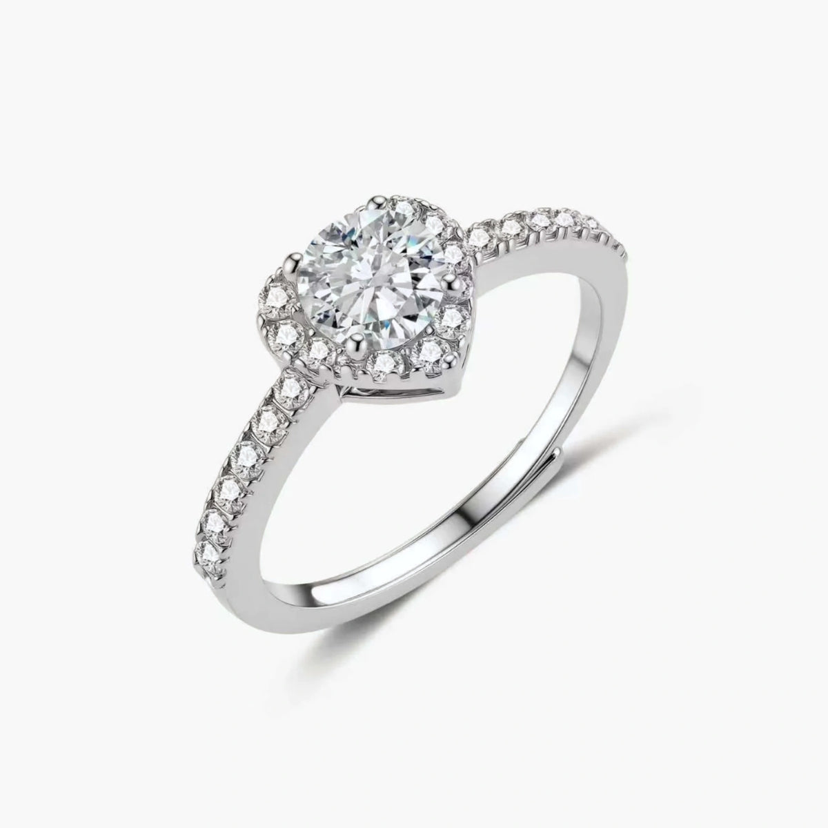 Heart-shaped halo ring with brilliant moissanite center stone surrounded by smaller crystals in sterling silver setting